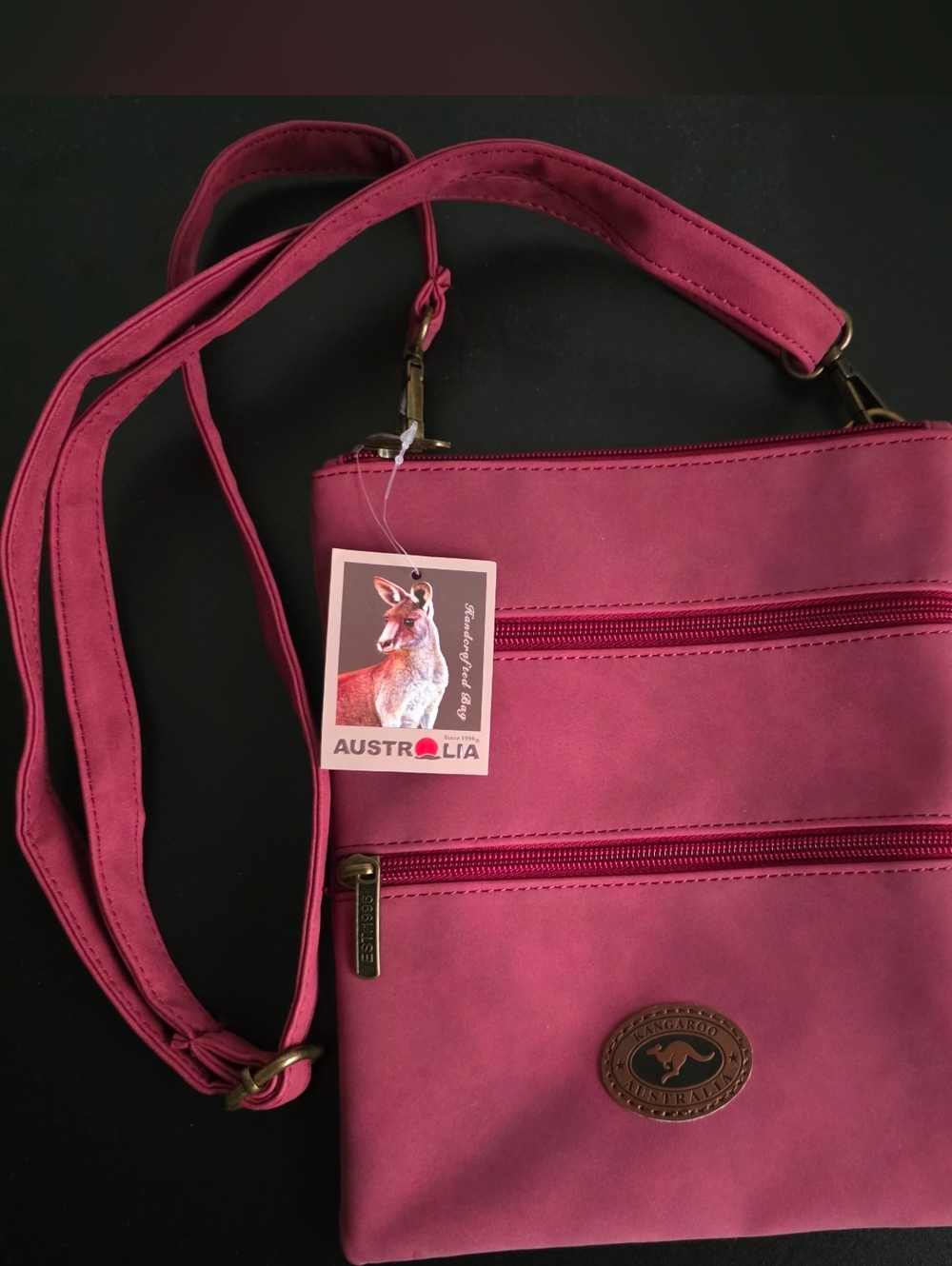 Compact Raspberry Pink Crossbody Bag with Kangaroo Emblem